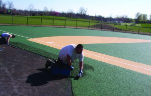 Installing EverTop for Miracle League baseball.