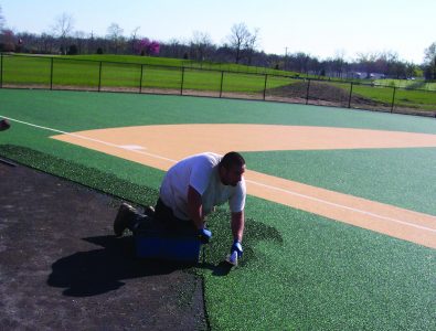 Installing EverTop for Miracle League baseball.