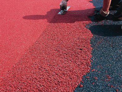 Spreading top layer of PlayBound Poured-in-Place.