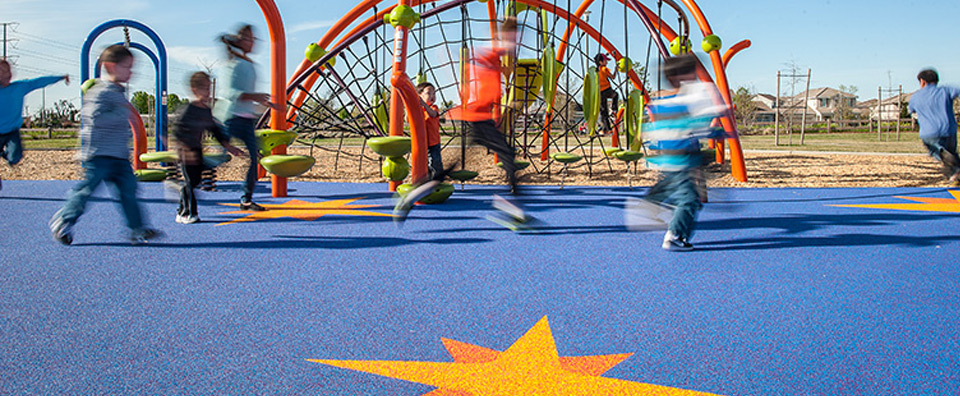 An image of children playing on an installation of PebbleFlex at Buscher Park