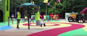 Children playing on a Surface America surface at a playground